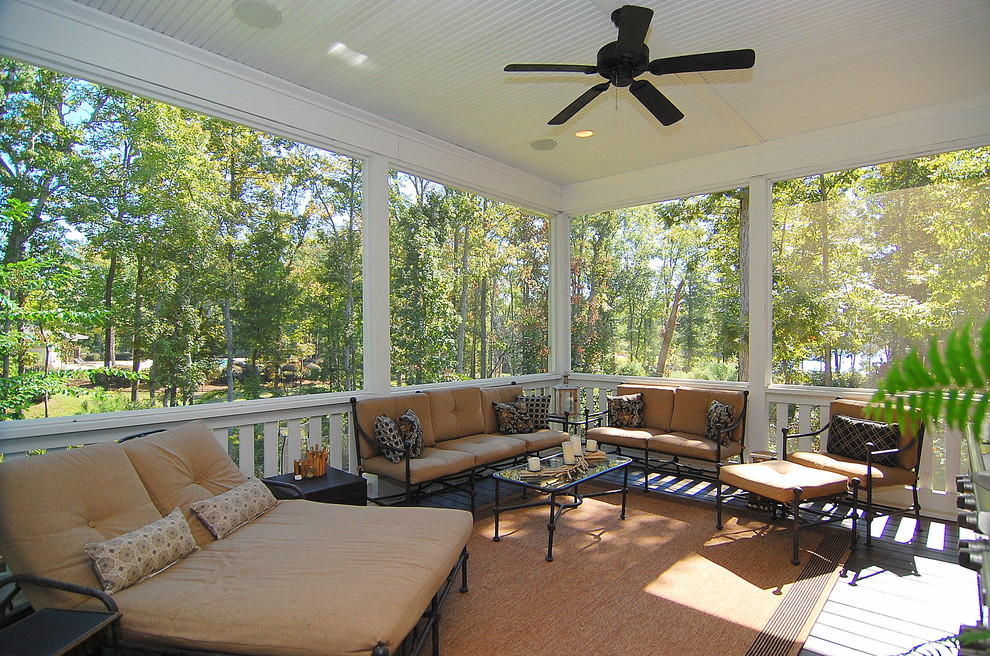 Example of a large classic backyard patio kitchen design in Charleston with decking and a roof extension