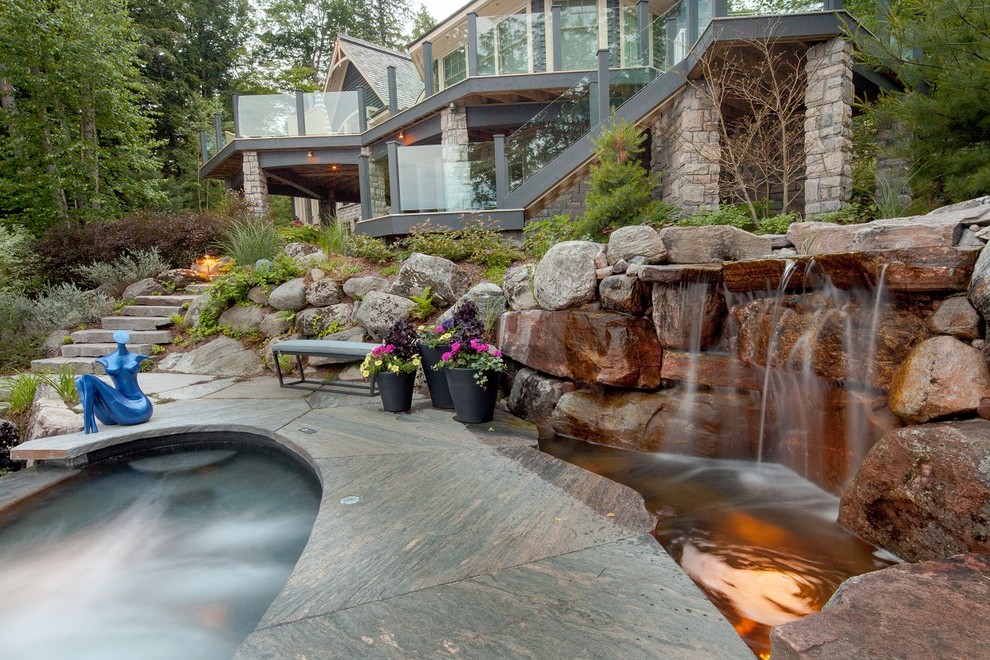 Inspiration for a large classic back patio in Toronto with an outdoor shower, natural stone paving and no cover.