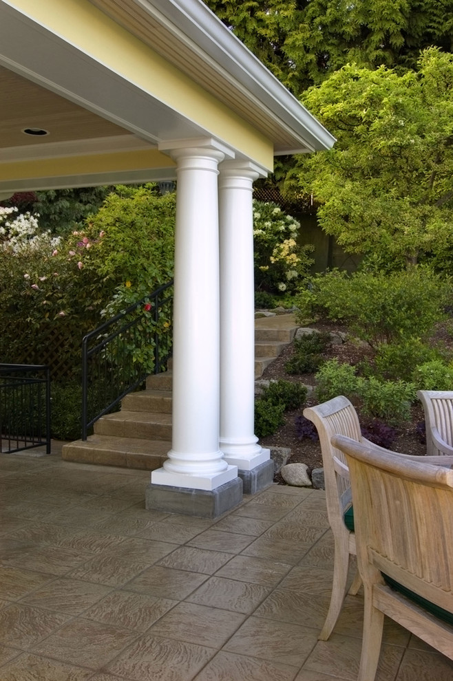 Inspiration for a large timeless backyard tile patio remodel in Seattle with a roof extension