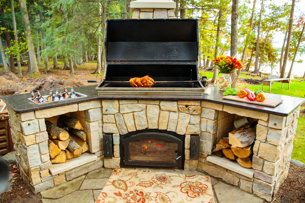 Inspiration for a large classic back patio in Detroit with an outdoor kitchen, natural stone paving and no cover.
