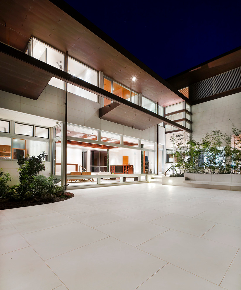Patio - huge contemporary backyard stone patio idea in Houston with no cover