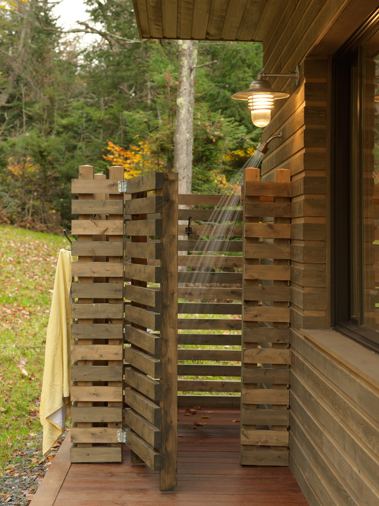 Example of a mid-sized mountain style backyard outdoor patio shower design in Charlotte with decking and a roof extension