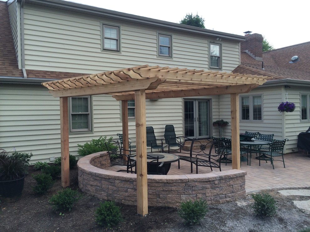 This is an example of a medium sized classic patio in Philadelphia with natural stone paving and a pergola.