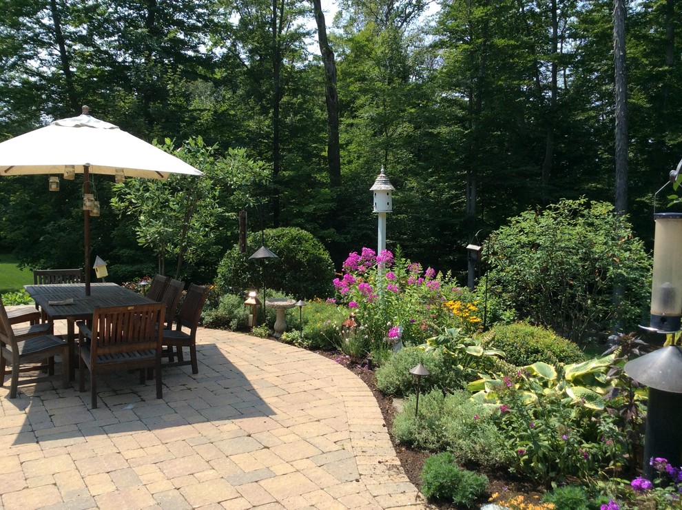 Inspiration for a mid-sized timeless backyard stone patio remodel in Cleveland with no cover