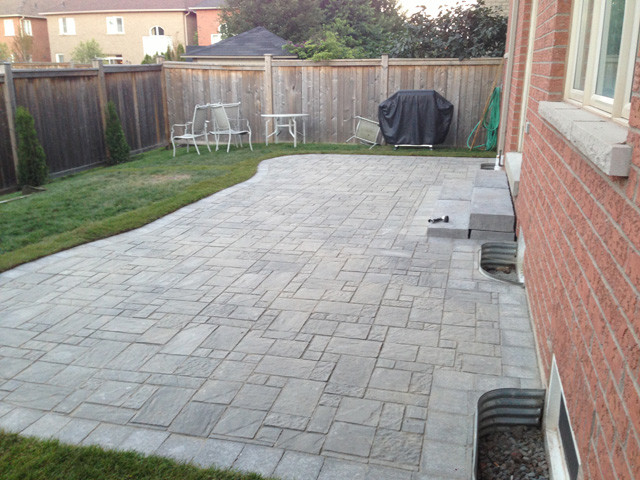 Design ideas for a medium sized traditional back patio in Toronto with stamped concrete.