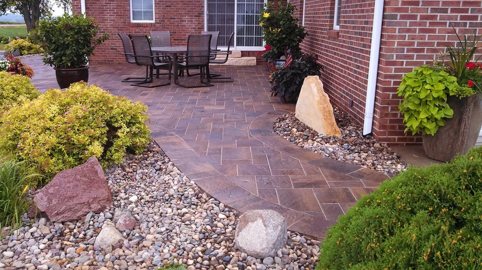Photo of a traditional patio in Cedar Rapids with a fire feature, concrete slabs and no cover.