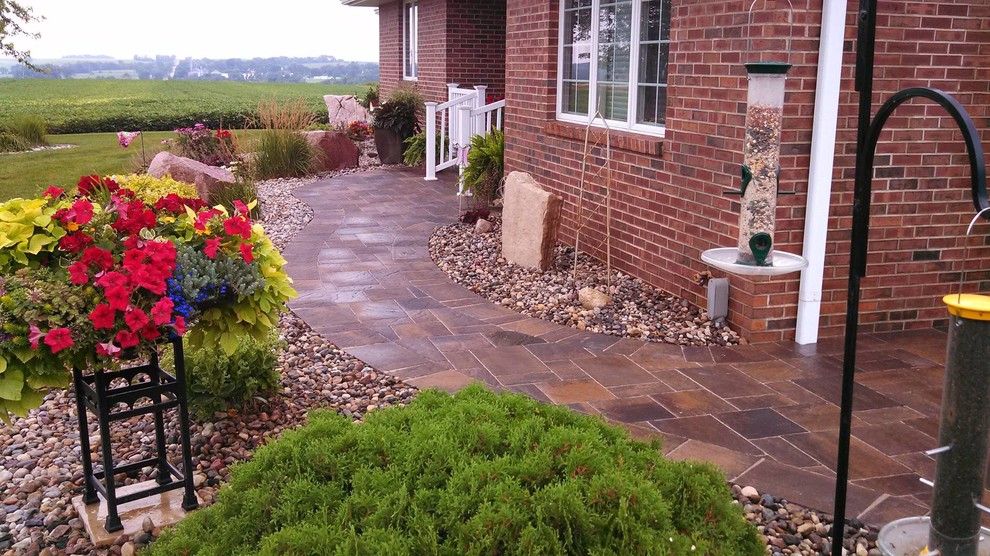 Photo of a classic patio in Cedar Rapids with a fire feature, concrete slabs and no cover.