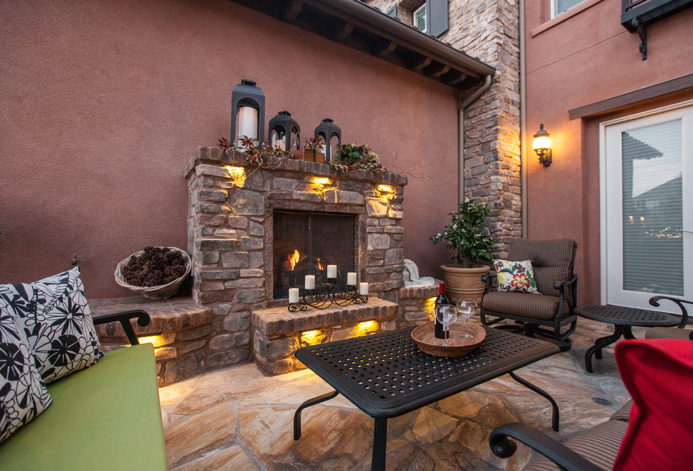 Patio - mid-sized mediterranean backyard stone patio idea in San Diego with a fire pit and no cover