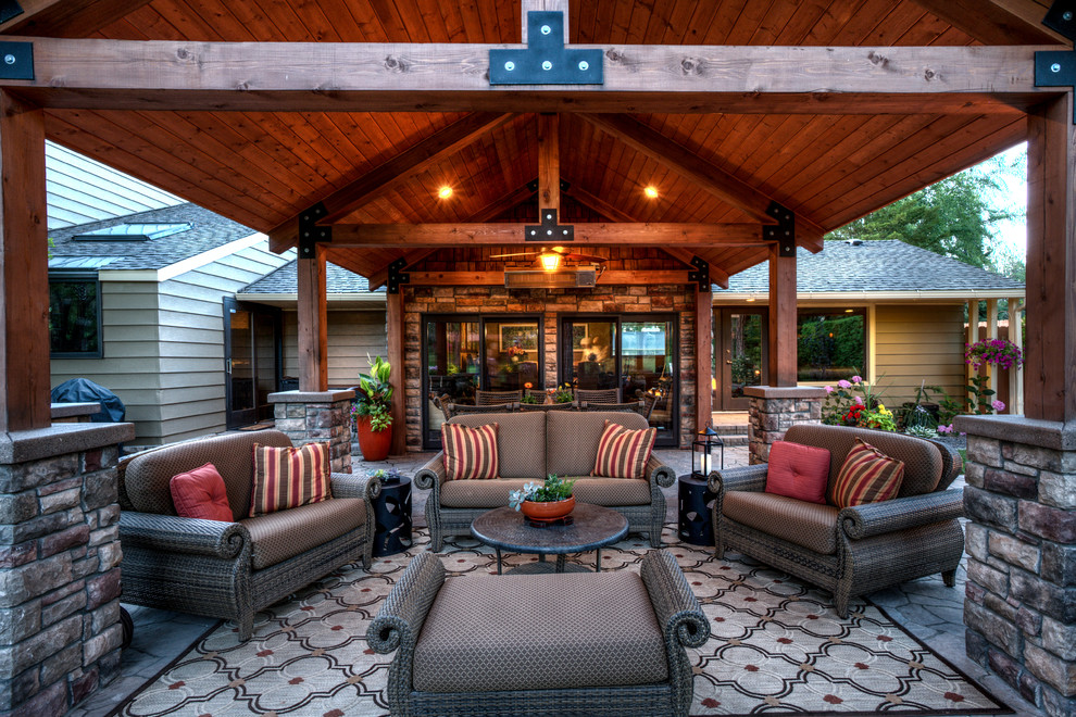 This is an example of a medium sized rustic back patio in Seattle with concrete paving and a roof extension.