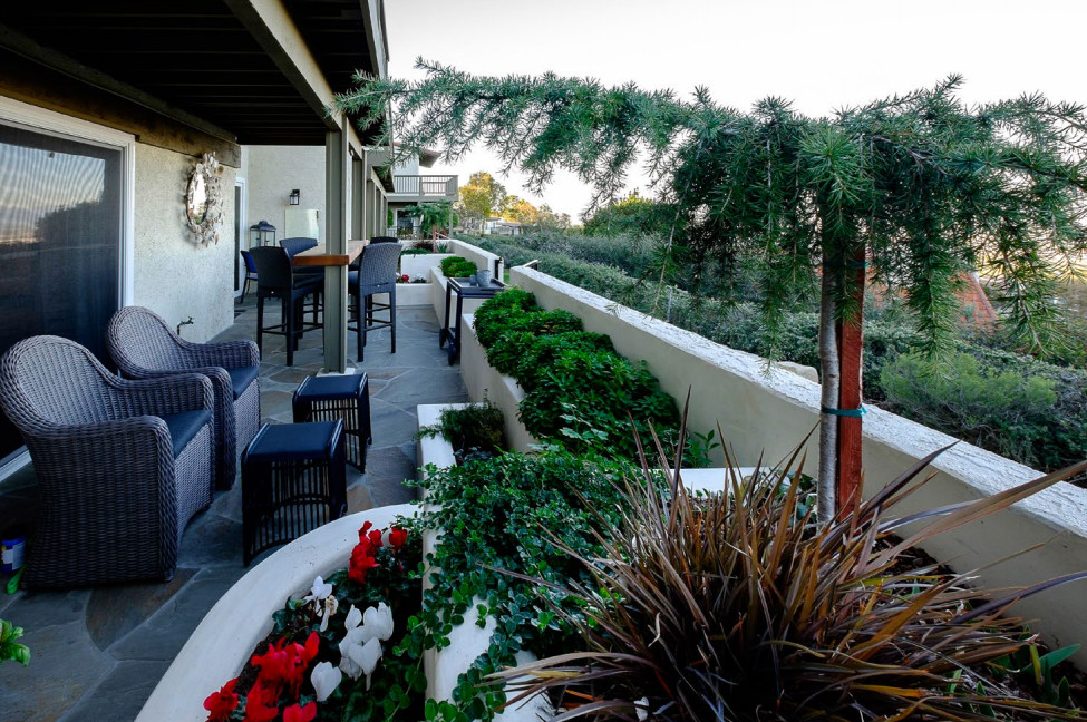 ロサンゼルスにある中くらいなエクレクティックスタイルのおしゃれな裏庭のテラス (天然石敷き、日よけなし) の写真