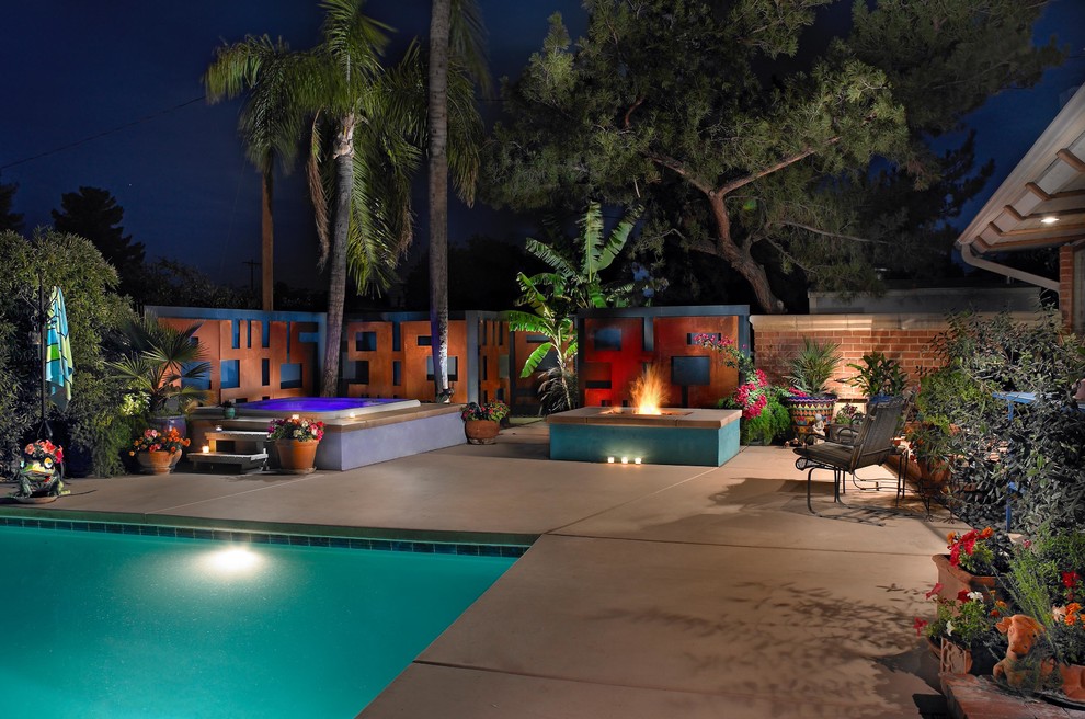 Inspiration for a mid-sized eclectic backyard concrete patio remodel in Phoenix with a fire pit and no cover