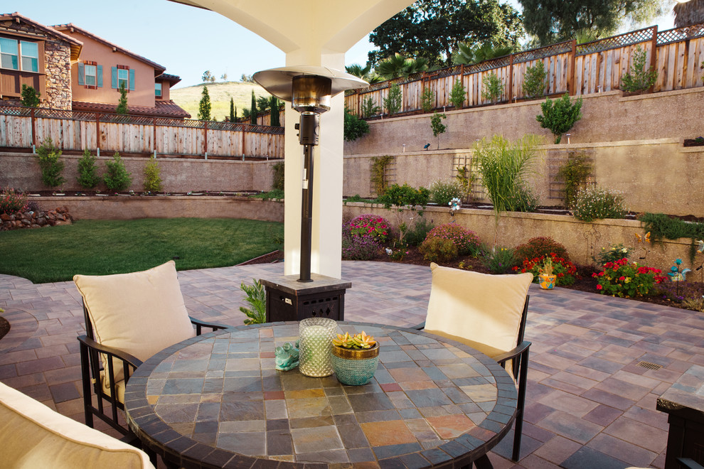 Design ideas for a large modern back patio in Sacramento with concrete paving.
