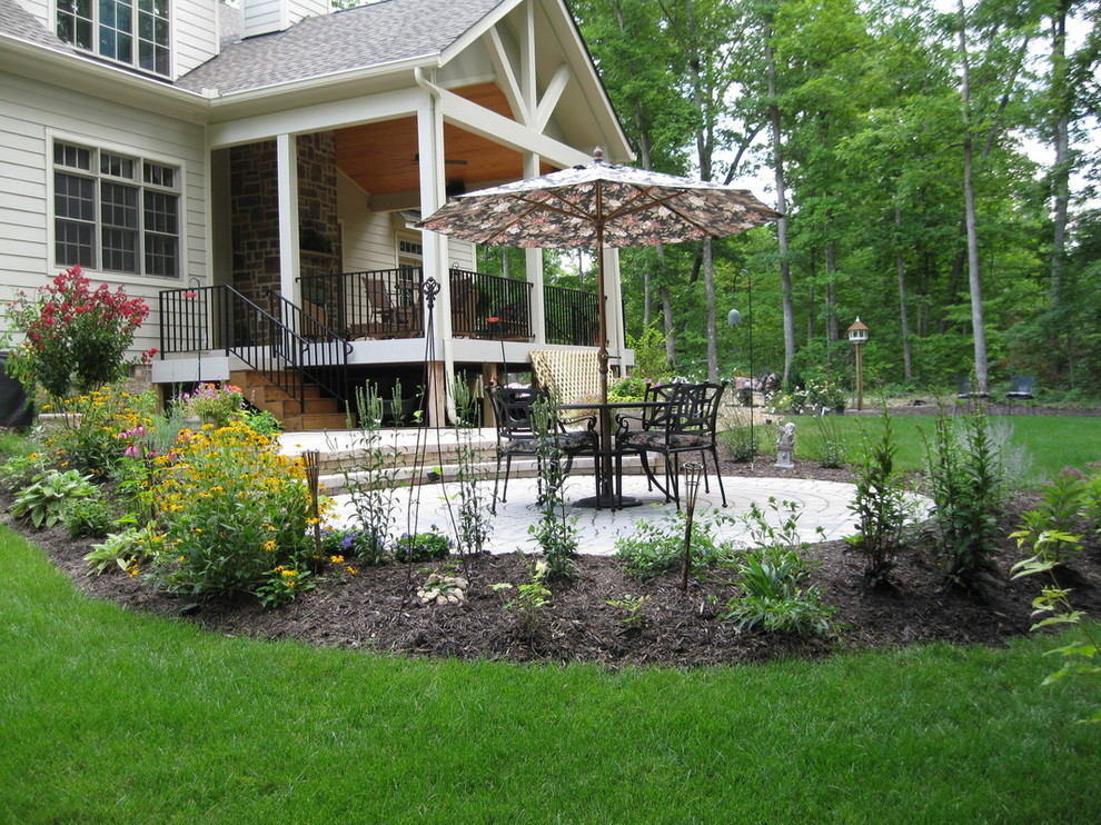 Mid-sized elegant backyard brick patio photo in Richmond with an awning