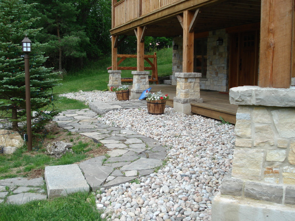 Photo of a medium sized rustic back patio in Toronto with decking and a roof extension.