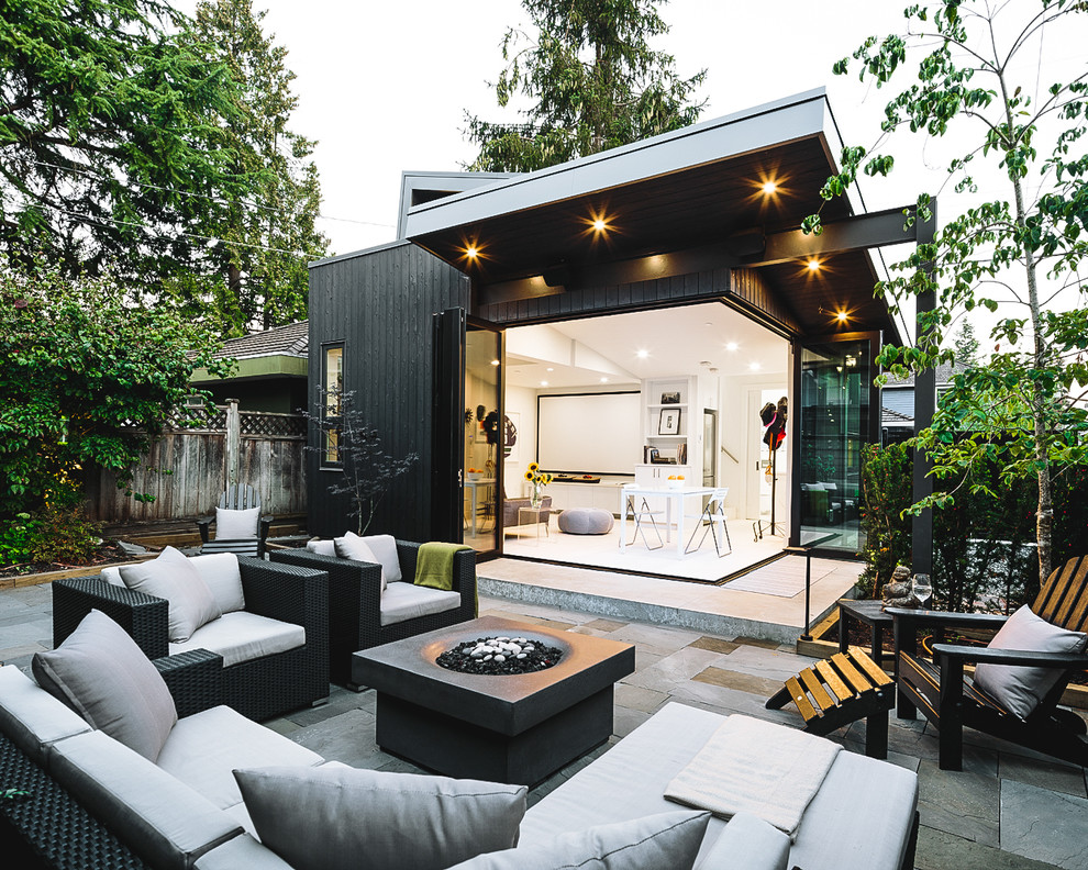 This is an example of a medium sized and black scandinavian bungalow detached house in Vancouver with wood cladding.