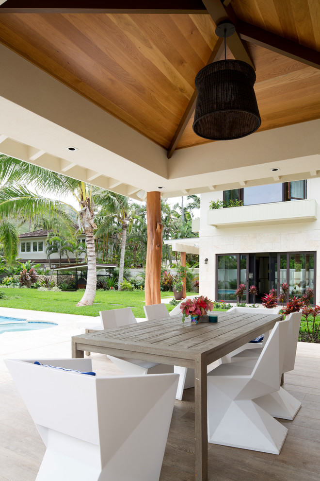 Inspiration for a beach style patio in Hawaii with a roof extension.