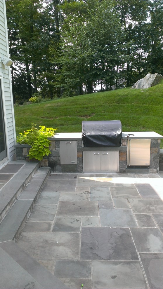 Mid-sized transitional backyard stone patio kitchen photo in New York with no cover