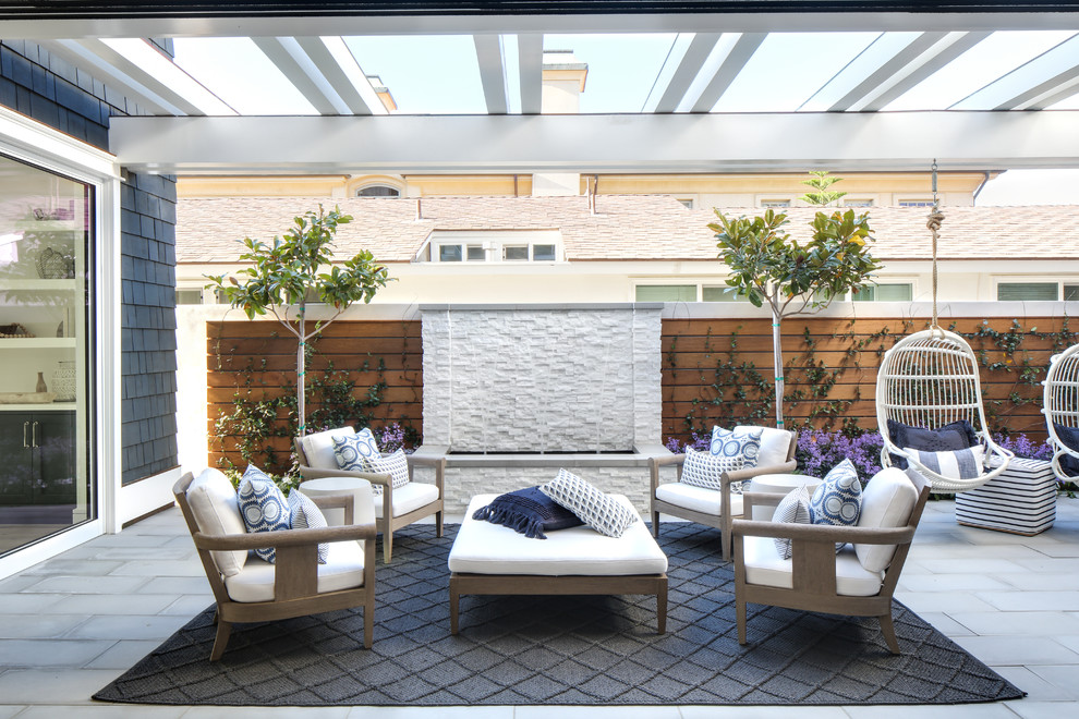 Nautical patio in Los Angeles with a water feature and a pergola.