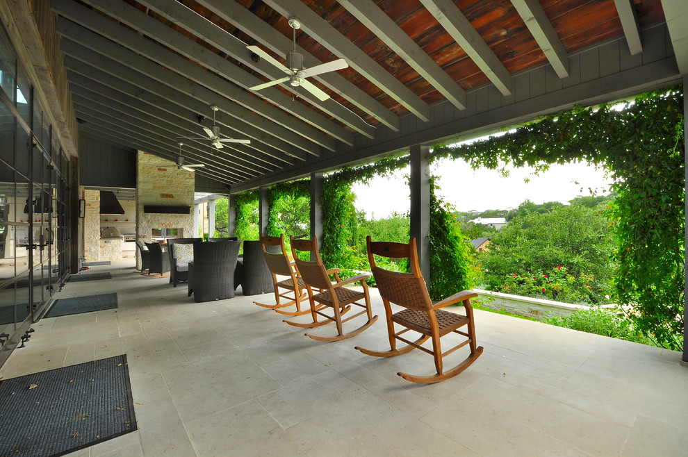 This is an example of a contemporary patio in Austin with a roof extension.