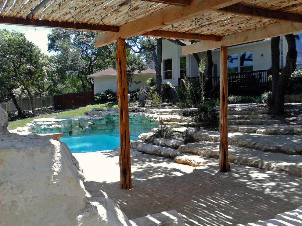 Large back patio in Austin with natural stone paving, a gazebo and a fire feature.