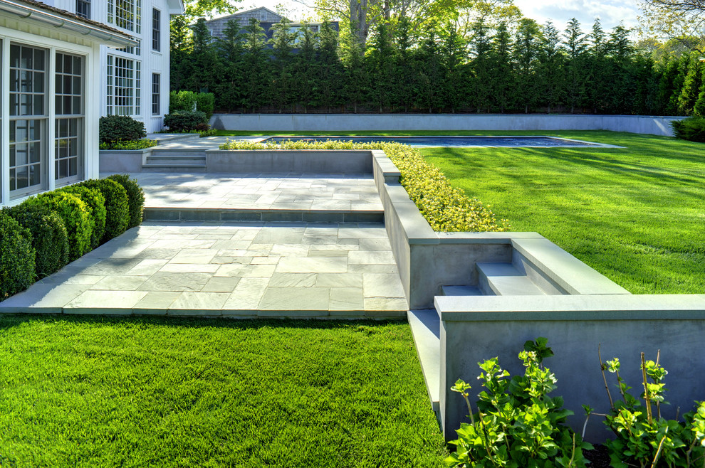 Design ideas for a large classic back patio in Manchester with natural stone paving and no cover.