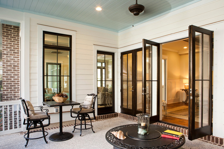 Inspiration for a mid-sized coastal backyard brick patio remodel in Charleston with a roof extension