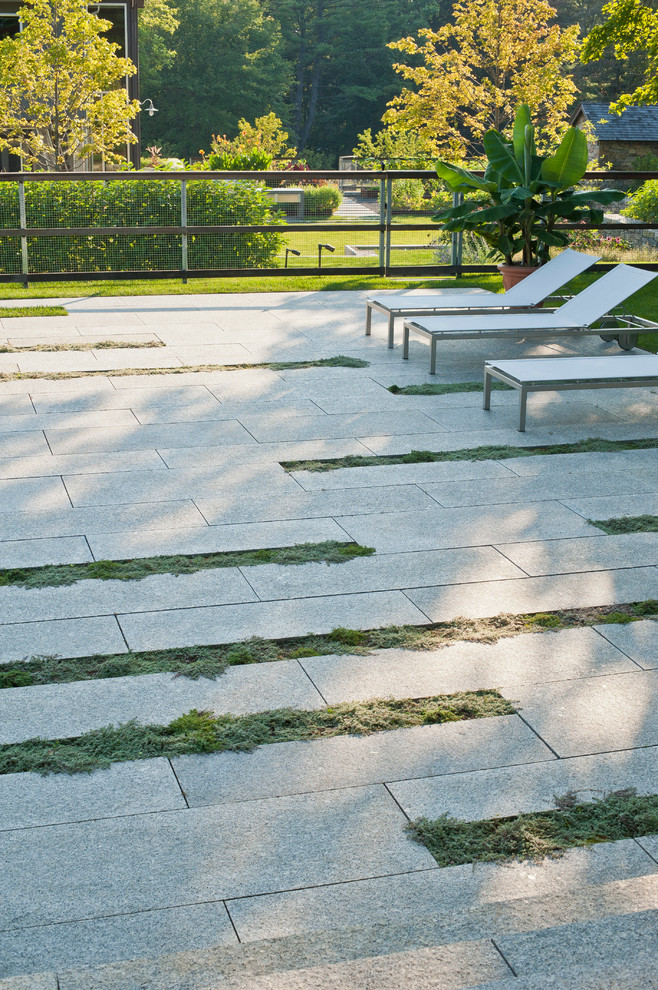 Photo of a contemporary patio in New York with no cover and fencing.