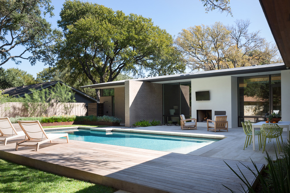 Design ideas for a medium sized contemporary back patio in Austin with a roof extension and decking.
