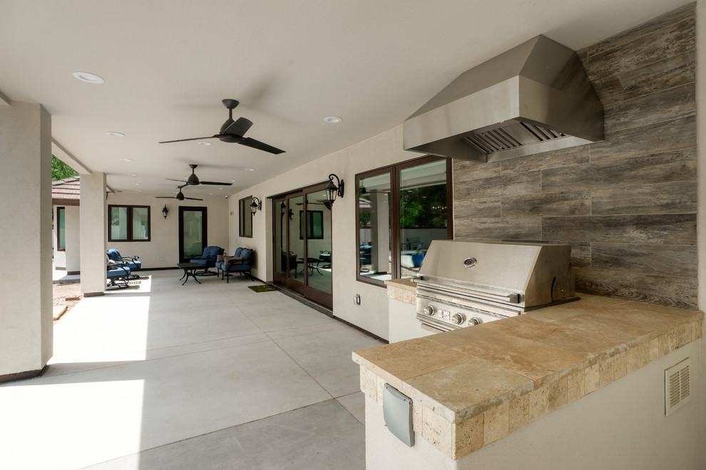 Example of a mid-sized trendy backyard patio kitchen design in Other with a roof extension