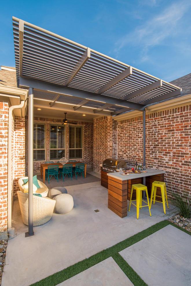 Small contemporary back patio in Dallas with an outdoor kitchen, concrete slabs and a pergola.