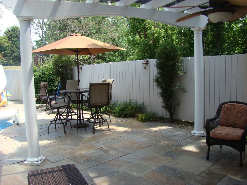Photo of a medium sized traditional back patio in Cincinnati with tiled flooring and a pergola.