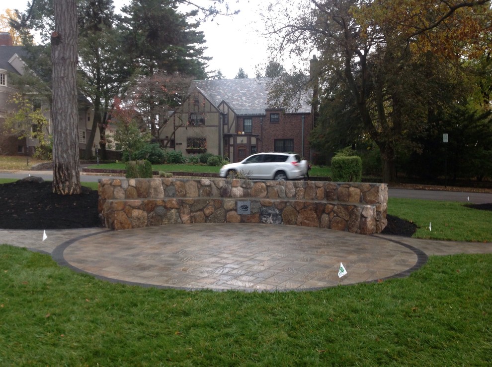 Inspiration for a large victorian courtyard concrete paver patio remodel in Boston with no cover
