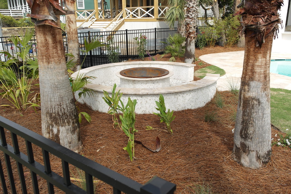 Inspiration for a mid-sized coastal backyard gravel patio remodel in Charleston with a fire pit and no cover