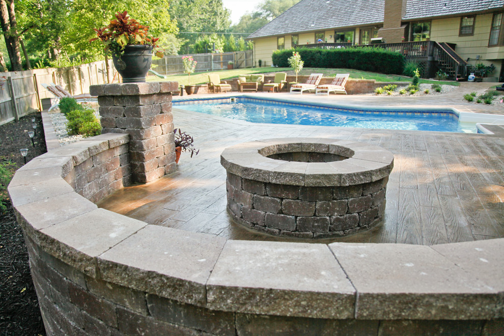 Photo of a contemporary patio in Kansas City with a fire feature and stamped concrete.