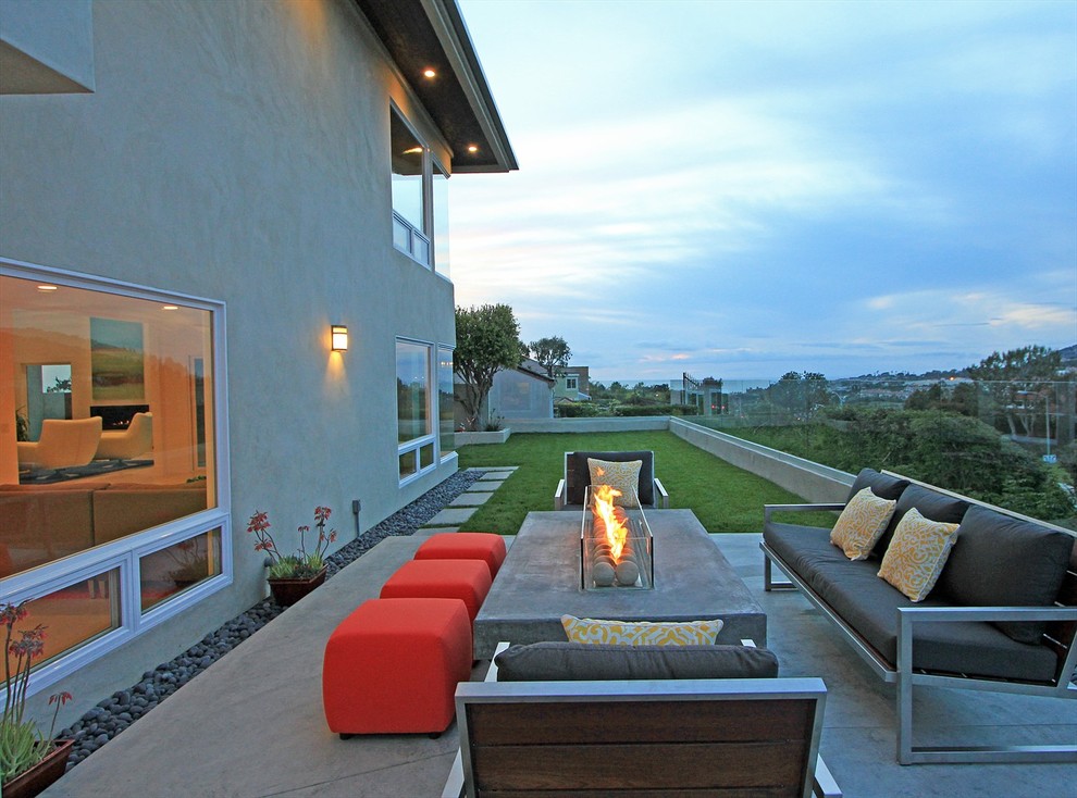 Design ideas for a contemporary back patio in Orange County with a fire feature.