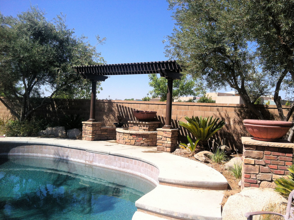 Example of a mid-sized tuscan backyard concrete patio design in Other with a fire pit and a pergola