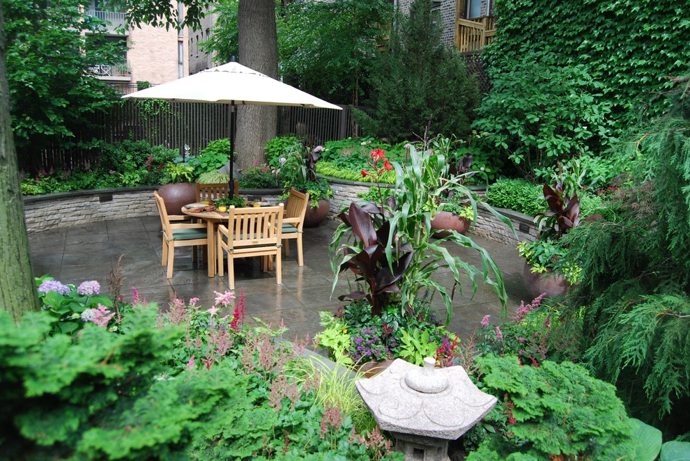 Patio - small traditional backyard stone patio idea in Chicago with no cover