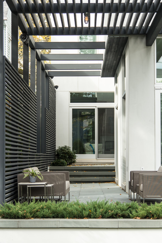 Inspiration for a contemporary patio in Chicago with a pergola.