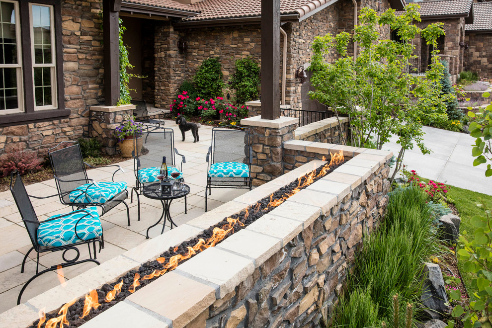 Large trendy courtyard stone patio photo in Denver with a fire pit and a pergola