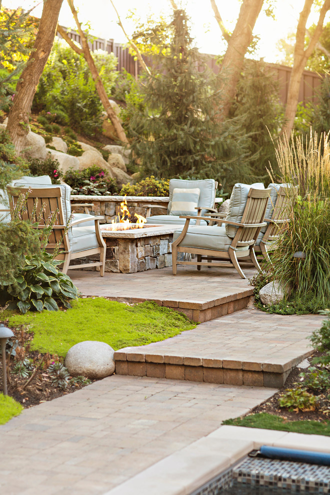 Elegant concrete paver patio photo in Salt Lake City with a fire pit and no cover