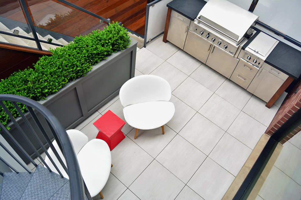Design ideas for a large contemporary courtyard patio in Chicago with tiled flooring and a gazebo.