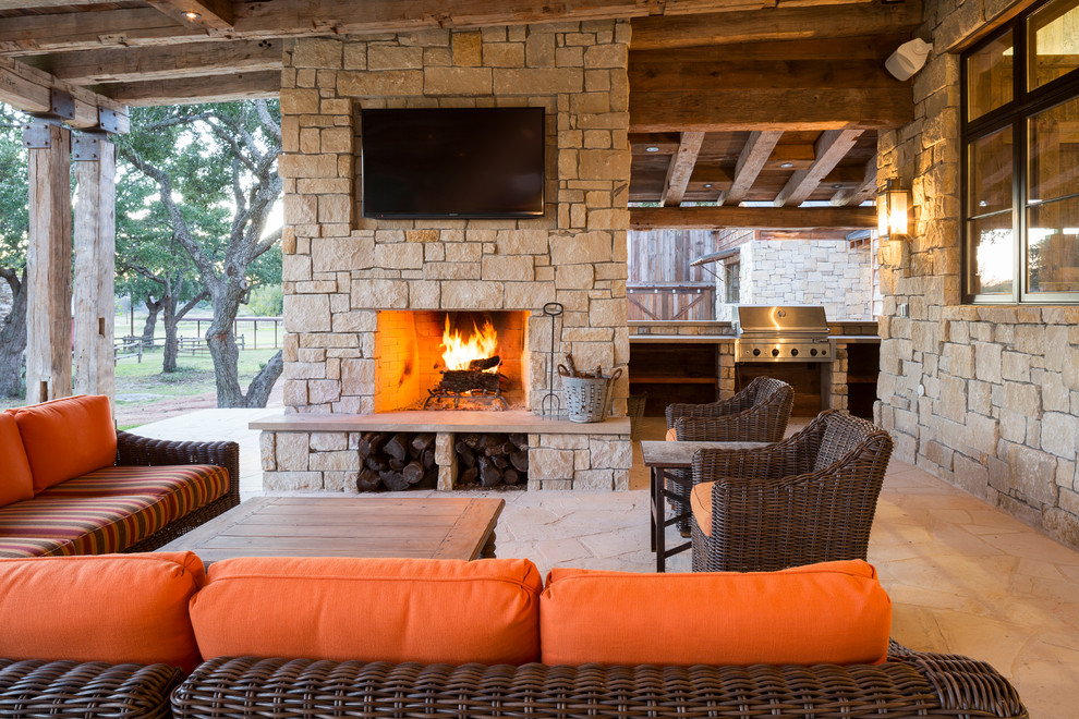 This is an example of a rustic patio in Austin with a roof extension and a bbq area.