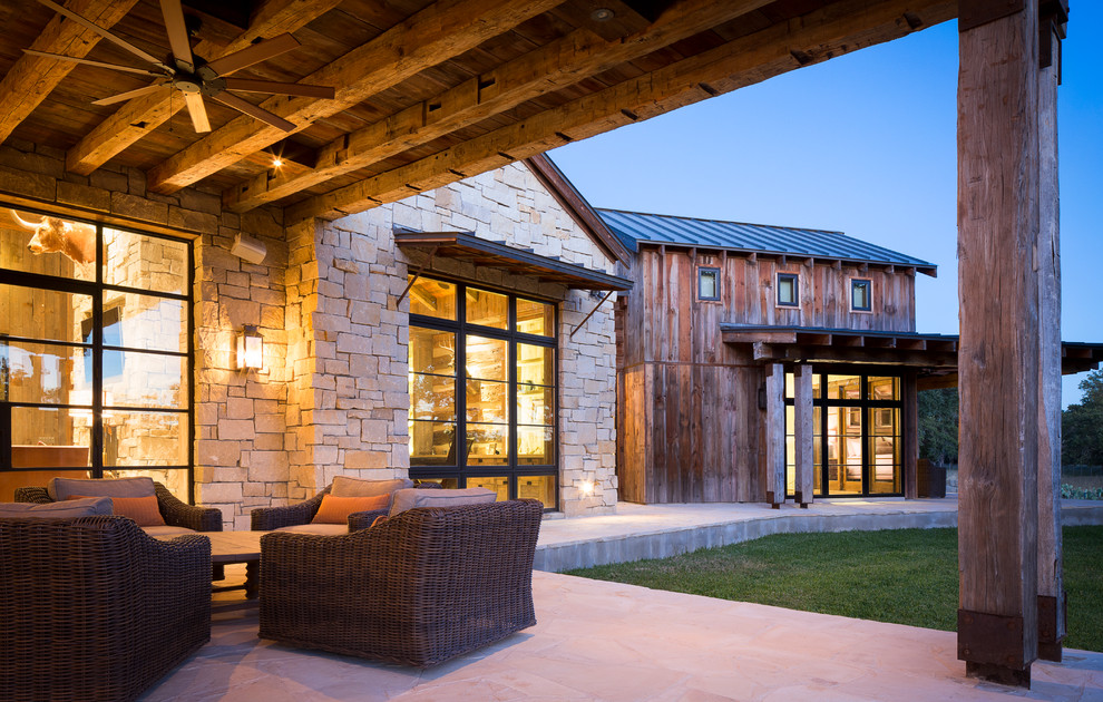 Inspiration for a rustic patio in Austin with a roof extension.