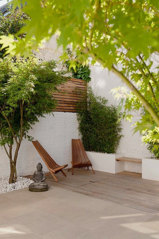 Patio - contemporary patio idea in Surrey with decking