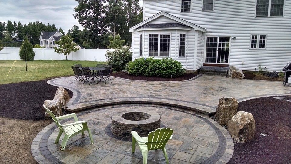 Example of a small trendy backyard concrete paver patio design in Manchester with a fire pit and no cover