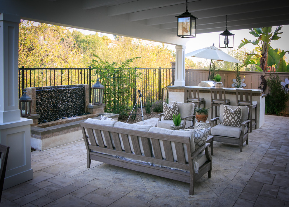 Inspiration for a small timeless backyard concrete paver patio fountain remodel in San Diego with a pergola