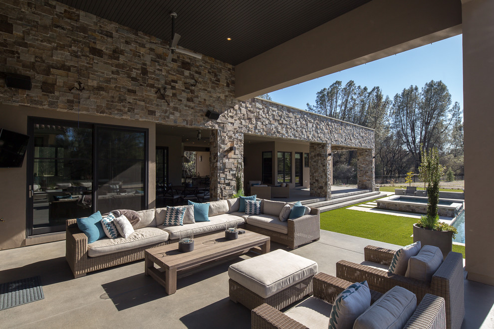Inspiration for a mid-sized transitional backyard concrete patio remodel in Sacramento with a roof extension
