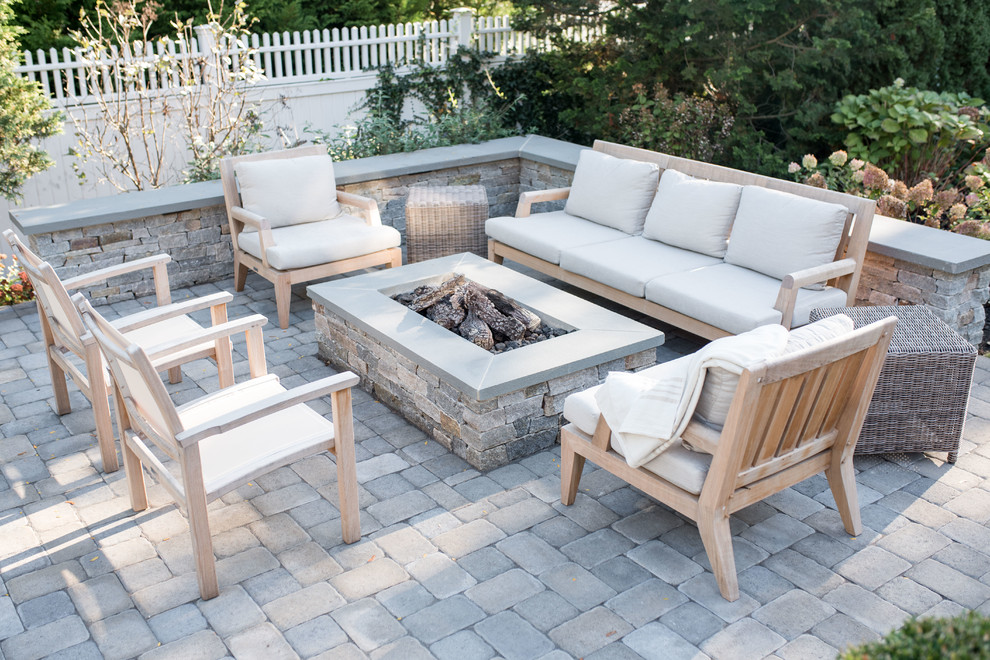 Example of a mid-sized beach style backyard concrete paver patio design in Boston with a fire pit