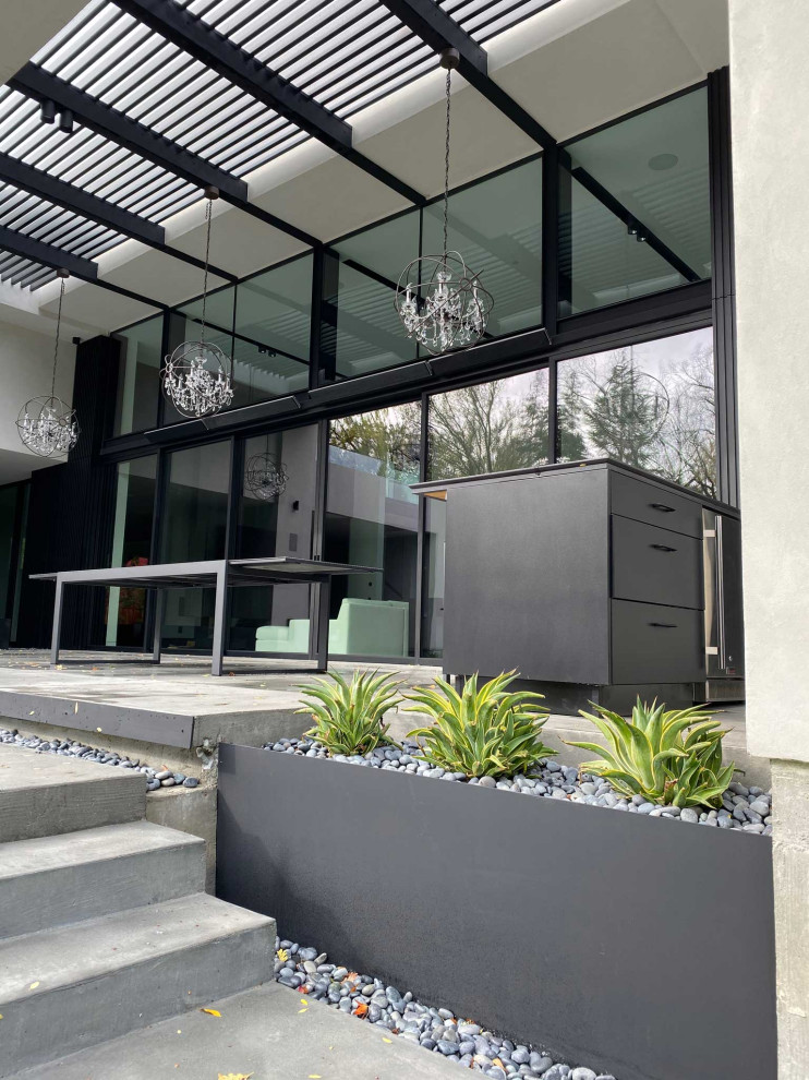 Patio kitchen - large contemporary backyard concrete paver patio kitchen idea in San Francisco with a pergola
