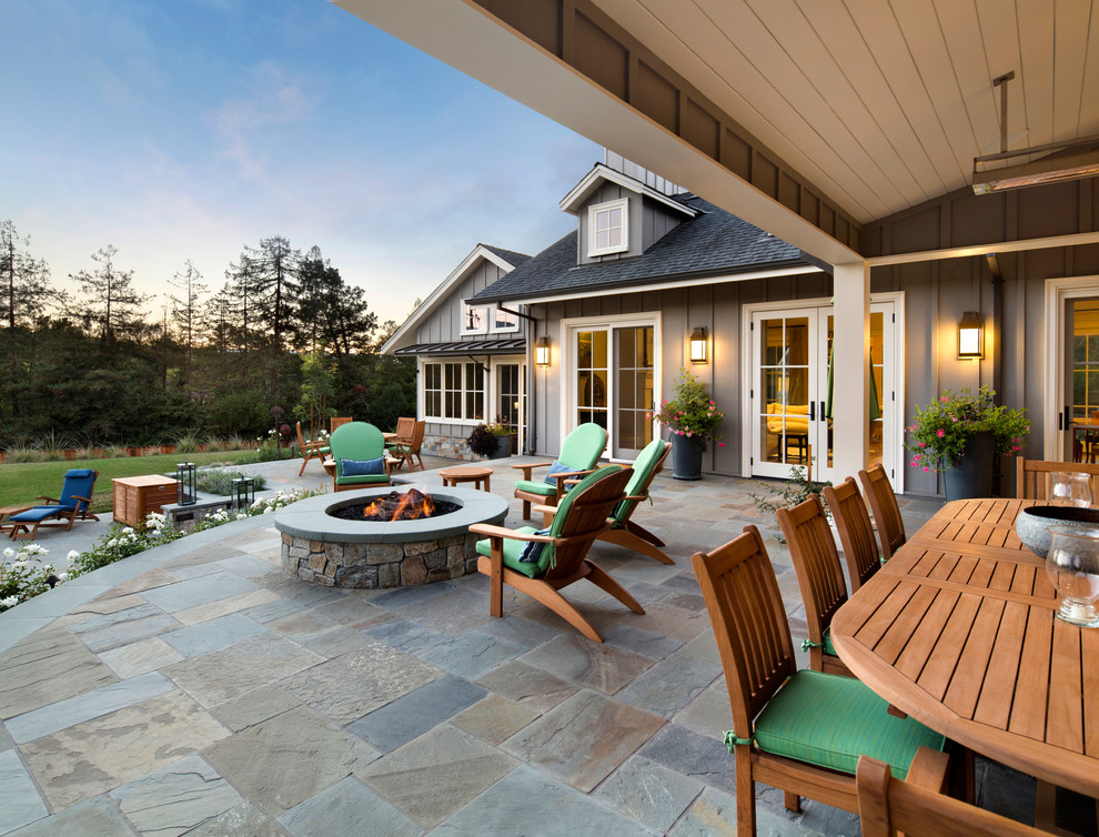 Inspiration for a traditional back patio in San Francisco with a fire feature and a roof extension.